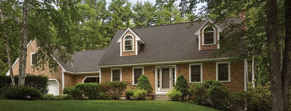 CEDAR IMPRESSIONS Individual 5″ Sawmill Shingles shown on a home