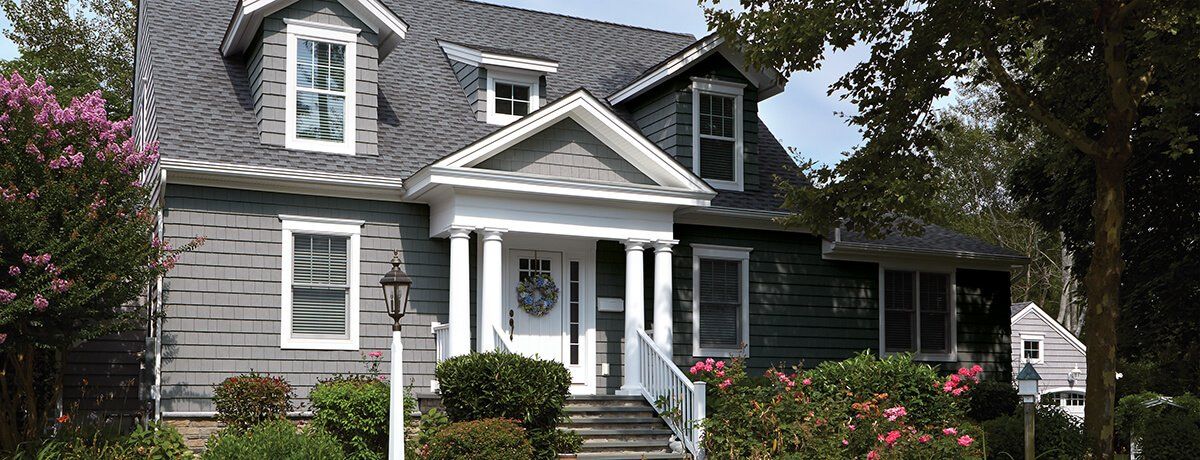 CEDAR IMPRESSIONS Single 7″ Straight Edge Perfection Shingles shown on a home