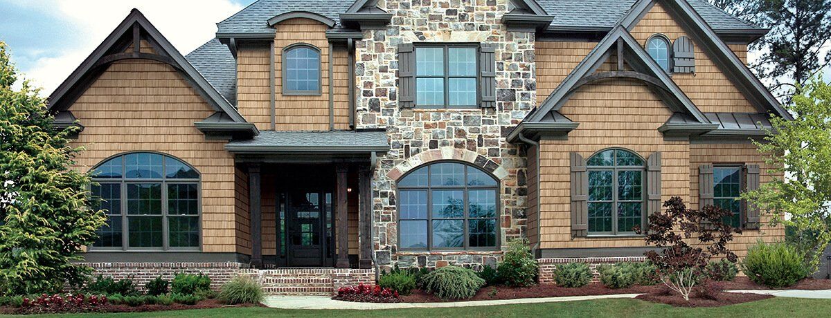 CEDAR IMPRESSIONS Double 7″ Straight Edge Rough-Split Shakes shown on a home