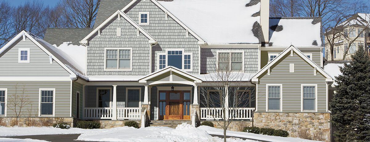 CEDAR IMPRESSIONS Double 9″ Staggered Rough-Split Shakes shown on a home